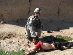 andrew_holmes_pulling_a_dead_afghan_boy_by_the_hair_in_2010-300x225.jpg